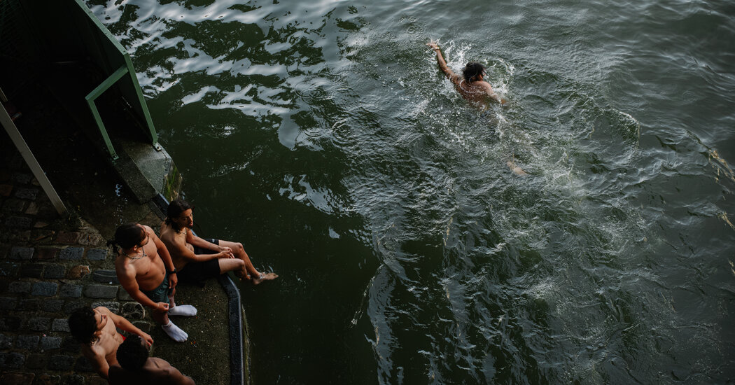 Parisians cooling off in Canal Saint-Martin during heatwave
