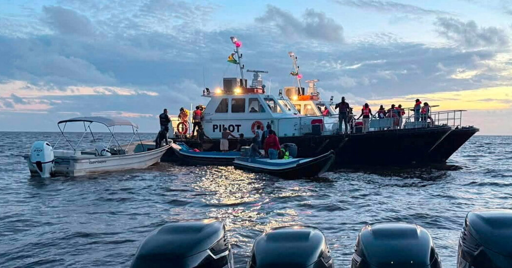 Rescue crews search after a ferry capsizes in Guyana