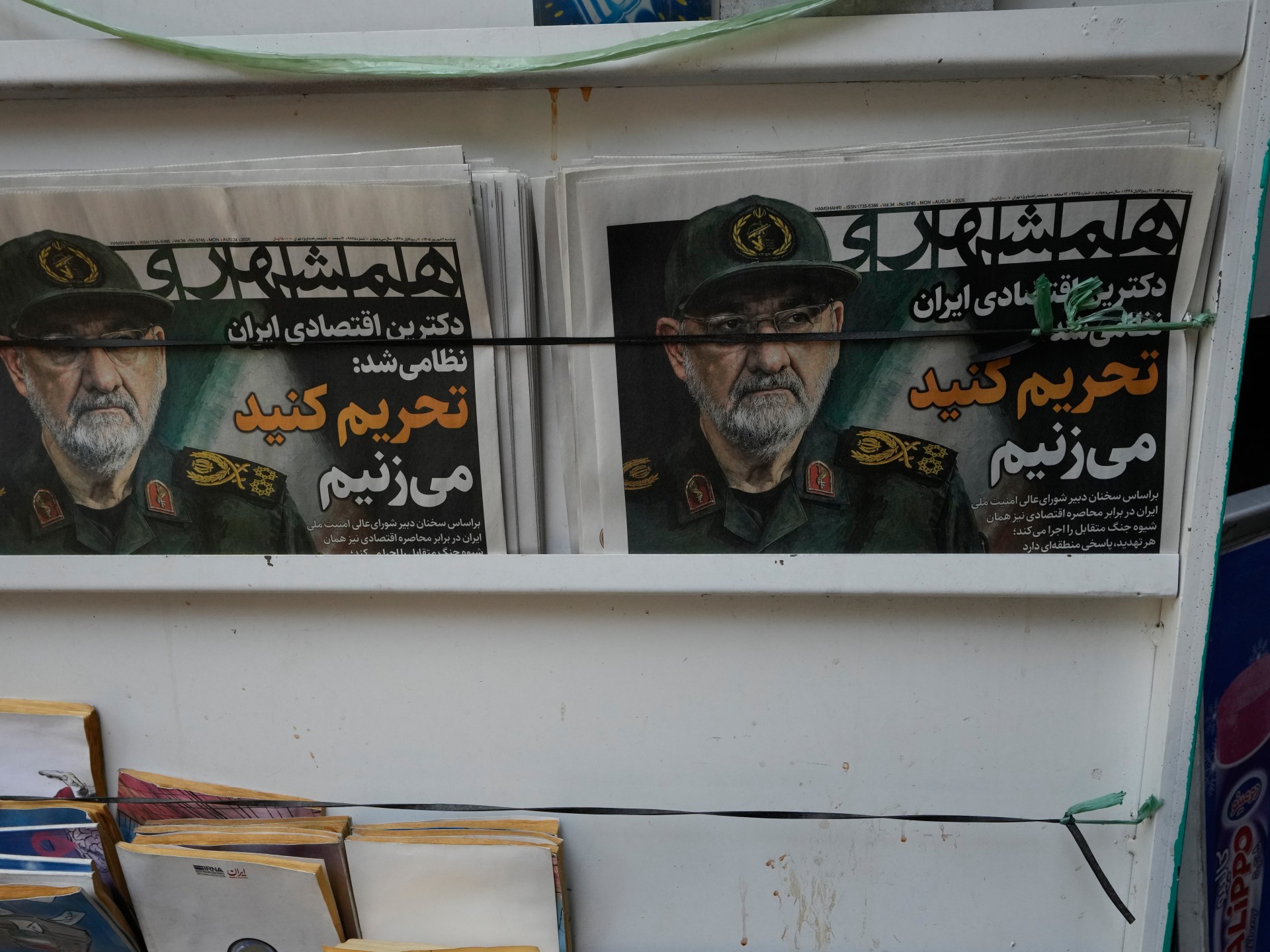 Iranian officials at port facility discussing Strait of Hormuz