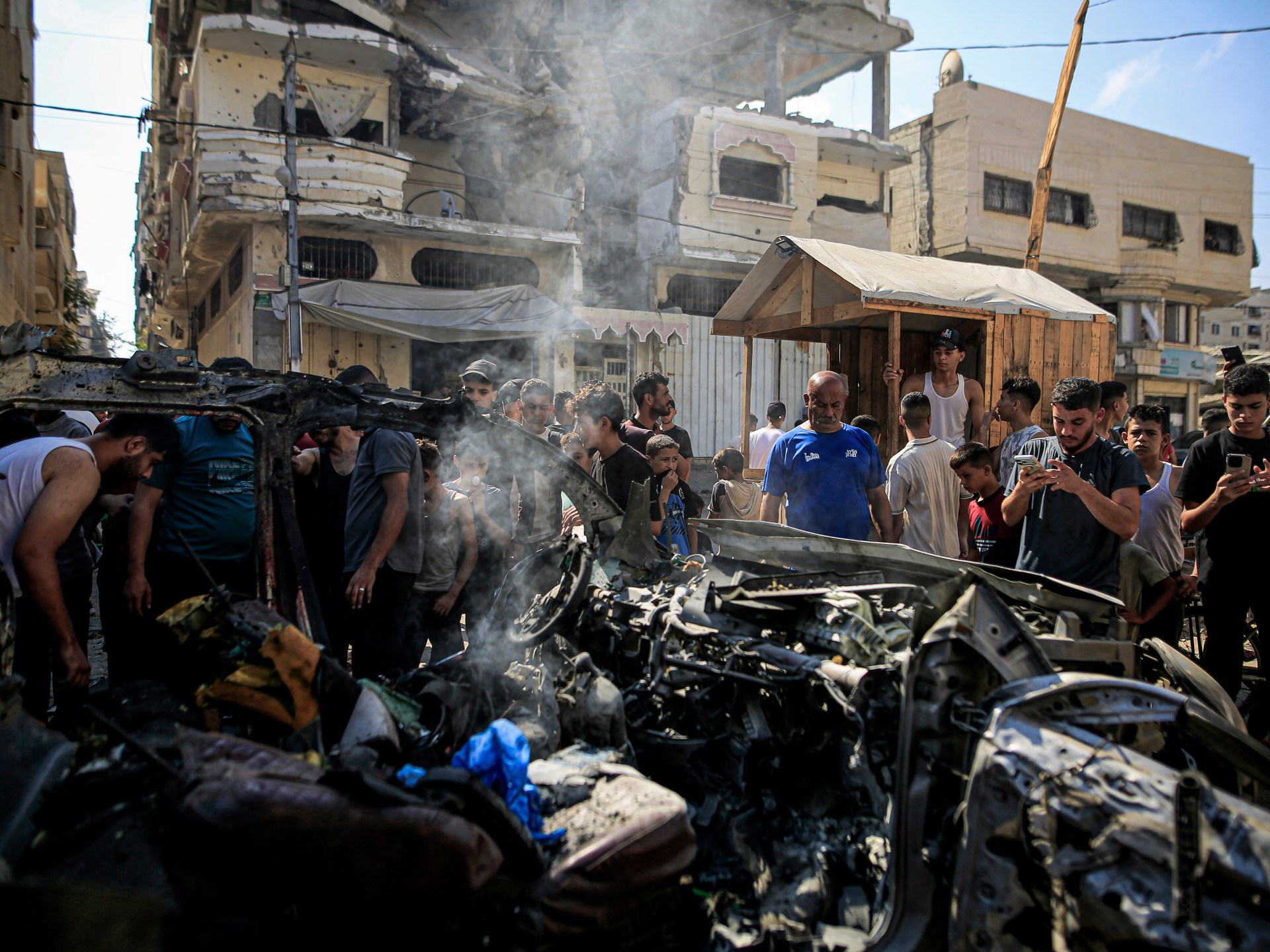 Palestinians inspecting the site of an Israeli strike in Gaza